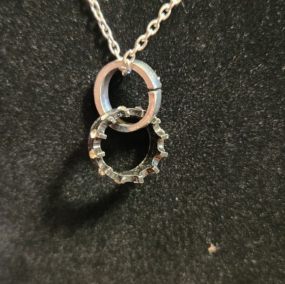 Silver colored necklace w/ a black crown ring & a silver colored ring. Pre-owned - Picture 2 of 3